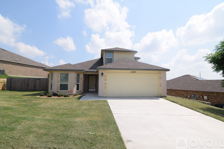 A house with a garage and a driveway is for sale.
