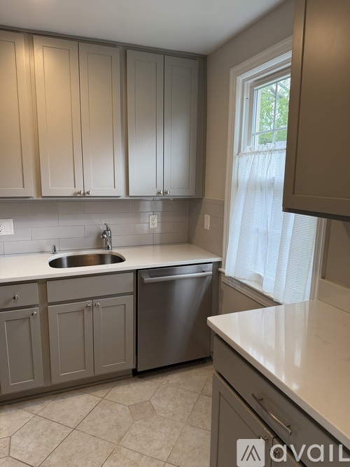 A kitchen with a sink and a window.