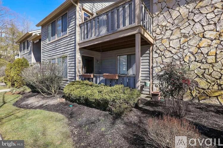 A house with a stone wall on the side.