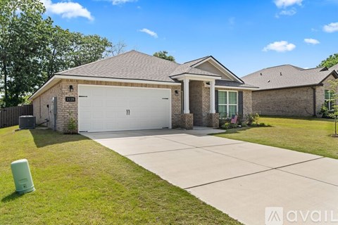 A house with a garage and a driveway in front.