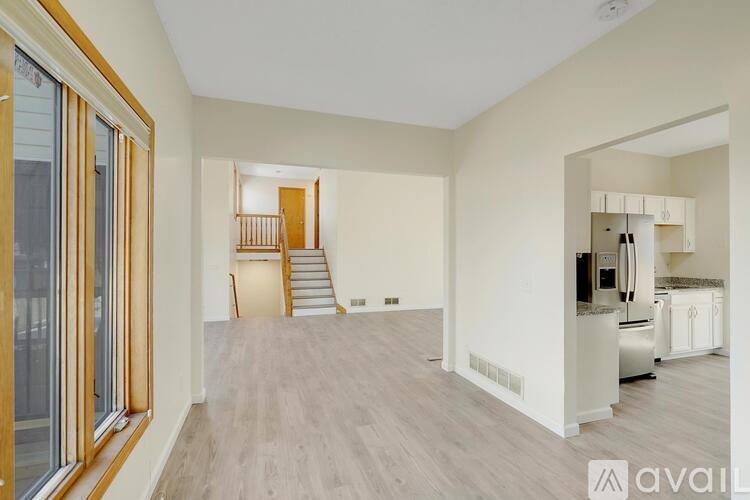 A spacious living area with a staircase leading to the upper floor.