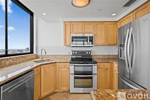 A kitchen with wooden cabinets and stainless steel appliances.