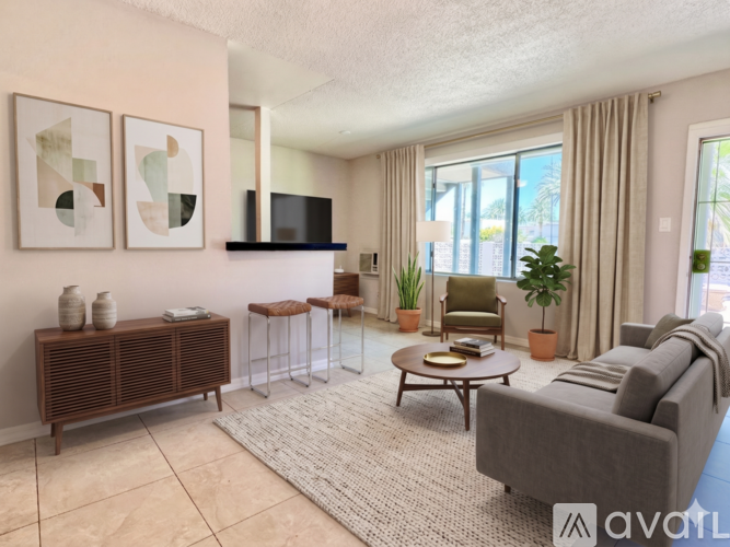 A living room with a grey sofa, a wooden cabinet, a coffee table, and a flat screen TV.