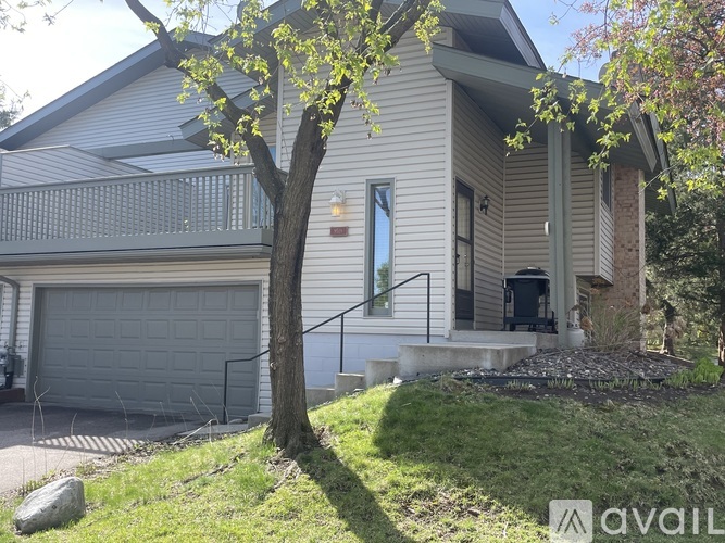 A house with a tree in front of it.