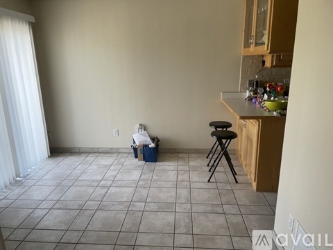 A kitchen area with a counter and a chair.