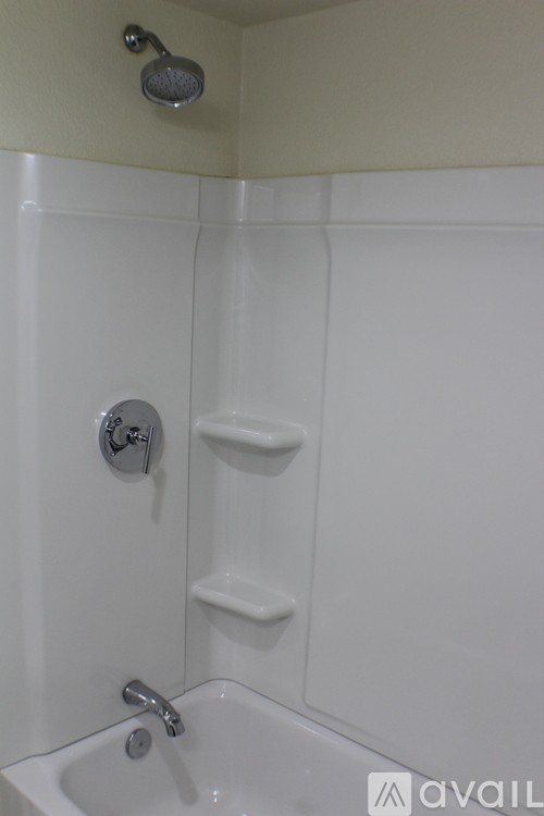 A white bathroom with a shower and sink.