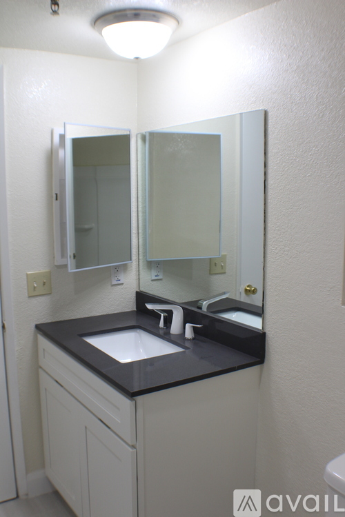 A bathroom with a sink and mirror.