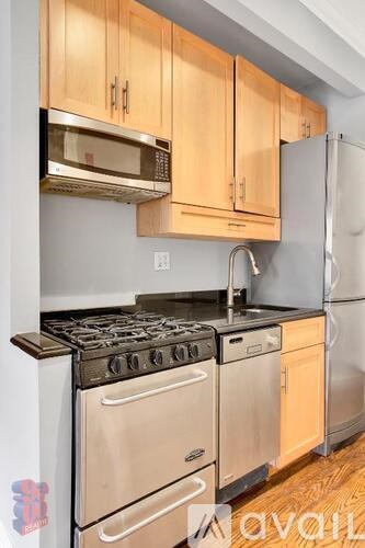 A kitchen with wooden cabinets and stainless steel appliances.
