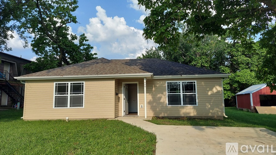 A house with a brown roof and beige siding is for sale.