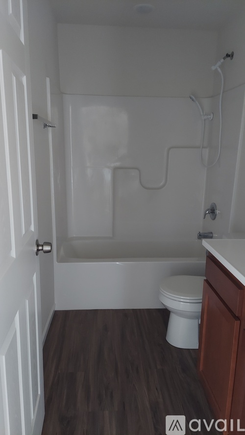 A small bathroom with a toilet and a bathtub.