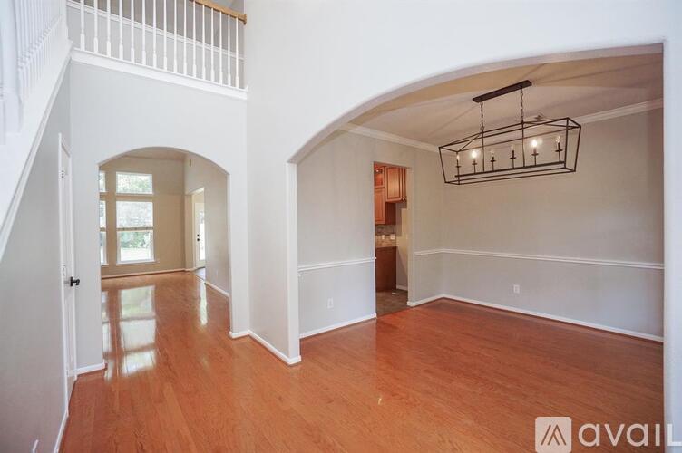 A large open room with wooden floors and white walls.