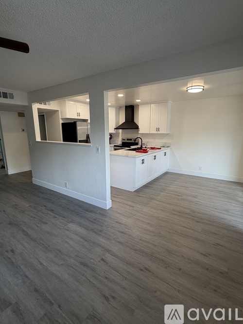 A kitchen with a stove top oven and a range hood.