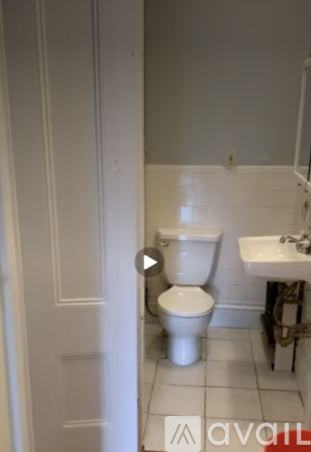 A white toilet is in a small bathroom.