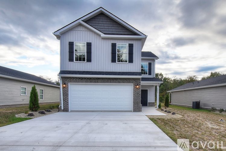 A two-story house with a garage is available for sale.