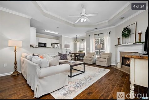 A living room with a white couch and a fireplace.