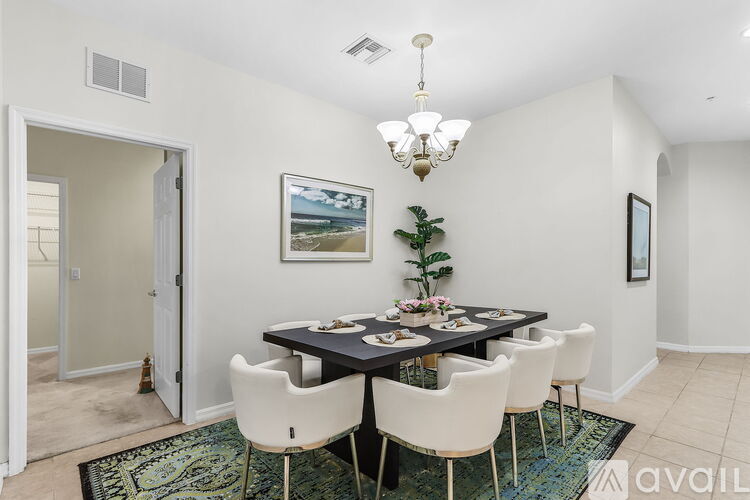 A dining room with a table set for six.