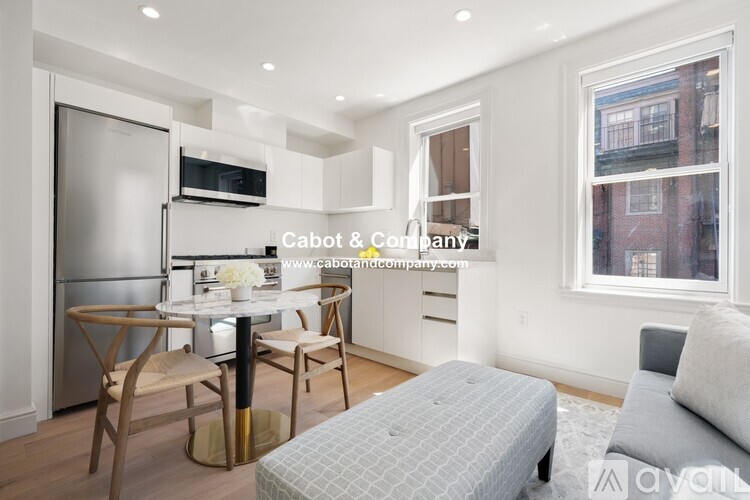 A modern kitchen with a dining table and chairs.