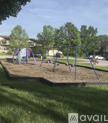 A playground with a swing set and a sandbox.