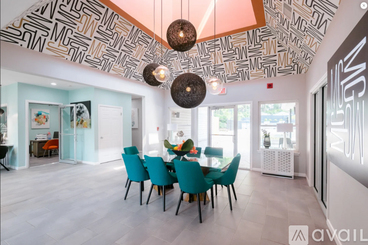 A dining room with a table set for six and a patterned ceiling.