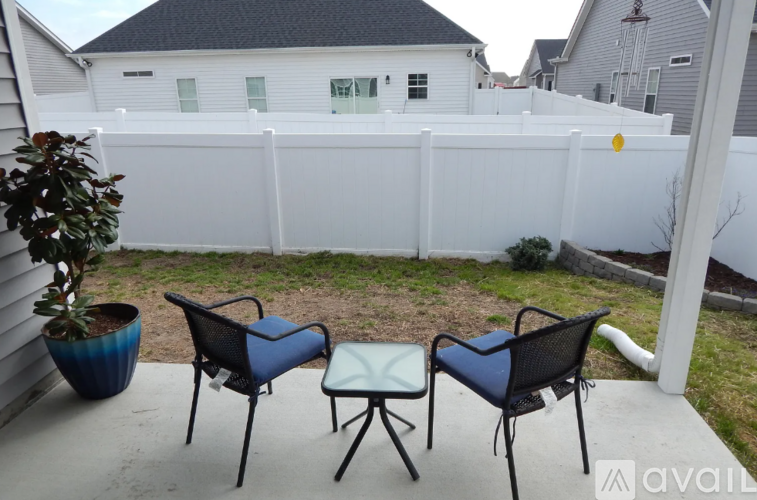 Three chairs are arranged on a patio.