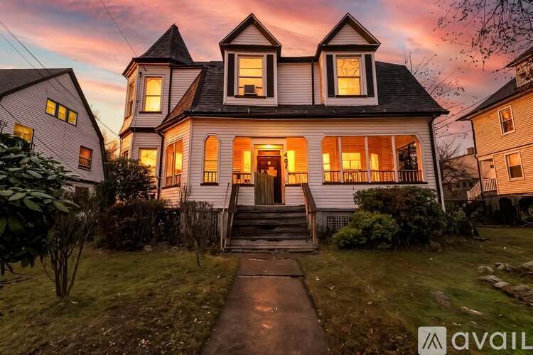 A house with a porch and a front yard.
