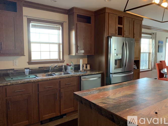 A kitchen with wooden cabinets and a granite countertop.