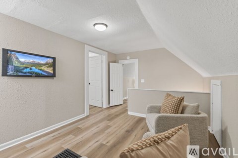 A living room with a television and a couch.