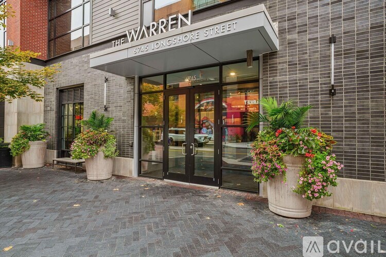 The entrance to a building with a glass door and a sign that reads "The Warren".