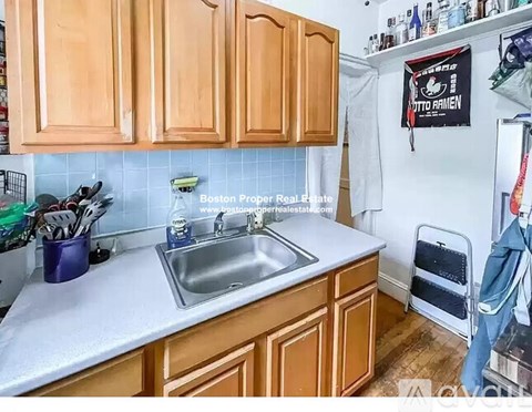 A kitchen with wooden cabinets and a white countertop.