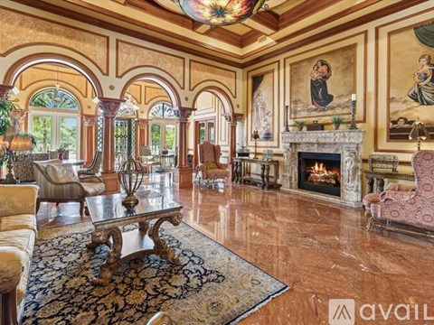 A living room with a fireplace and a painting on the wall.