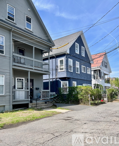 A row of houses with a clear blue sky above them.