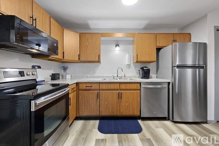 A kitchen with wooden cabinets and stainless steel appliances.