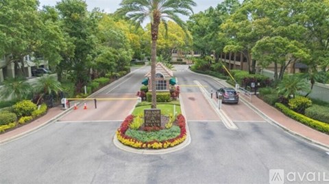 A street view with a sign in the middle of the road.