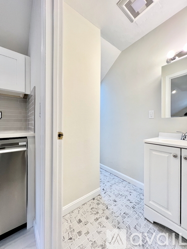 A white door is open to a bathroom.