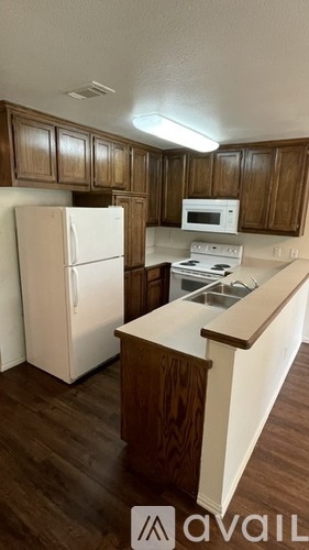 A kitchen with a white refrigerator and a white stove top oven.