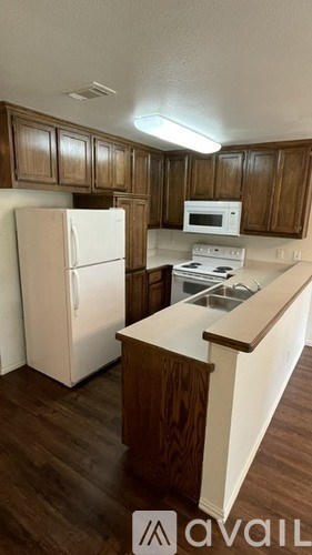 A kitchen with a white refrigerator and a white stove top oven.