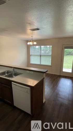 A kitchen with a sink and a dishwasher.