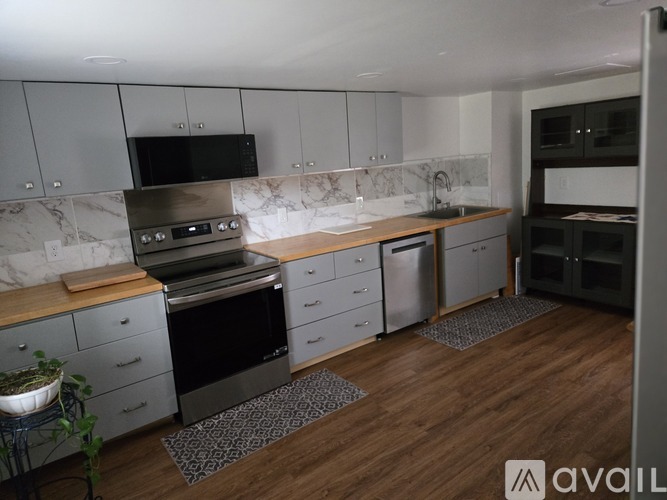 A kitchen with a black oven and a black microwave.