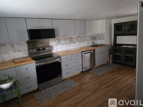 A kitchen with a black oven and a black microwave.