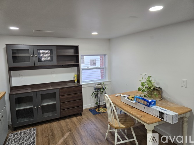 A kitchen with a wooden table and a white chair.
