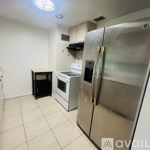 A kitchen with a stainless steel refrigerator and a white oven.