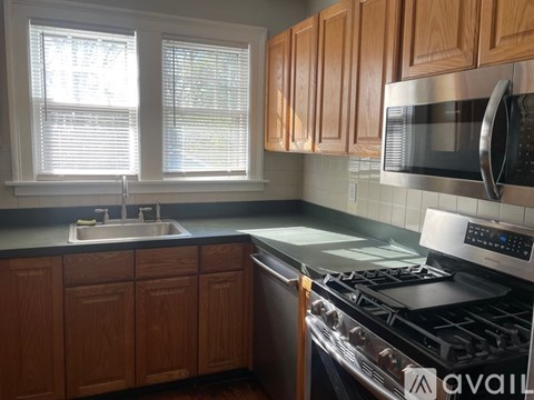 A kitchen with wooden cabinets and a black stove top.
