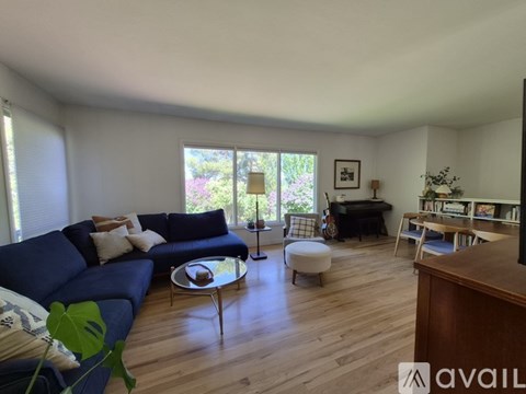 A living room with a blue couch and a coffee table.