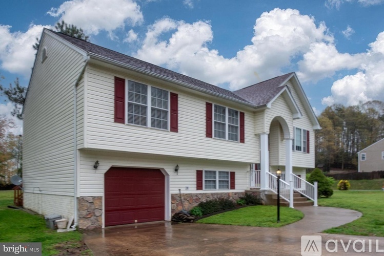 A house with a red garage door is for sale.