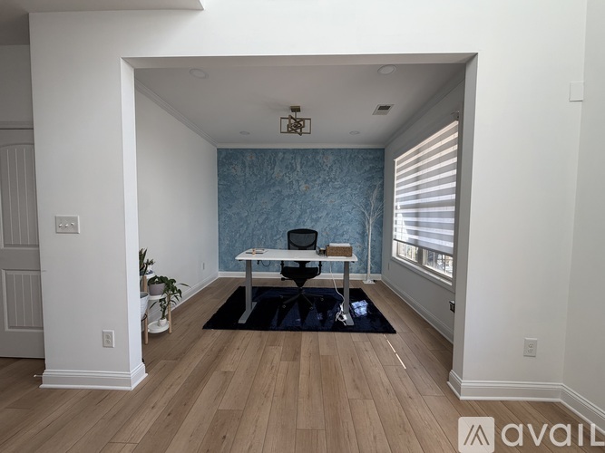A room with a desk and a computer.