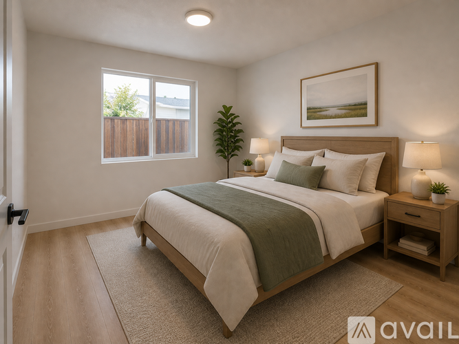A bedroom with a large bed and a painting on the wall.