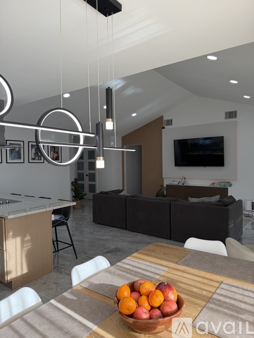 A modern kitchen with a dining table and chairs.