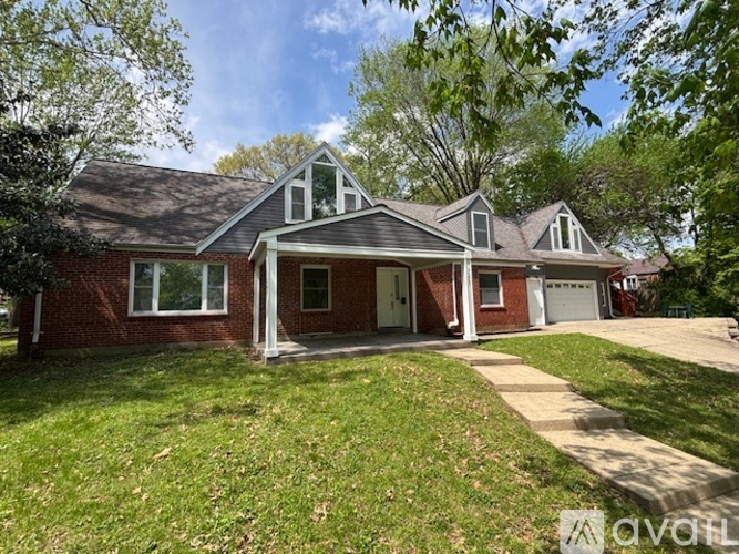 A house with a red brick exterior and a white garage door.