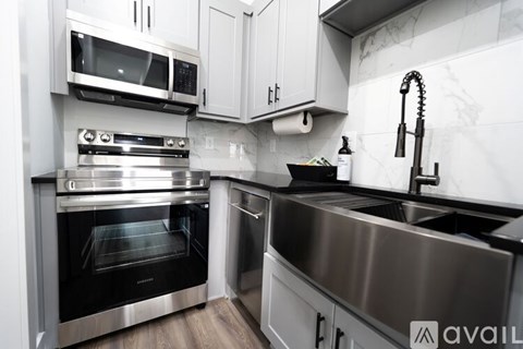 A modern kitchen with a stainless steel sink and oven.