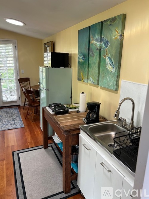 A kitchen with a wooden table and a sink.